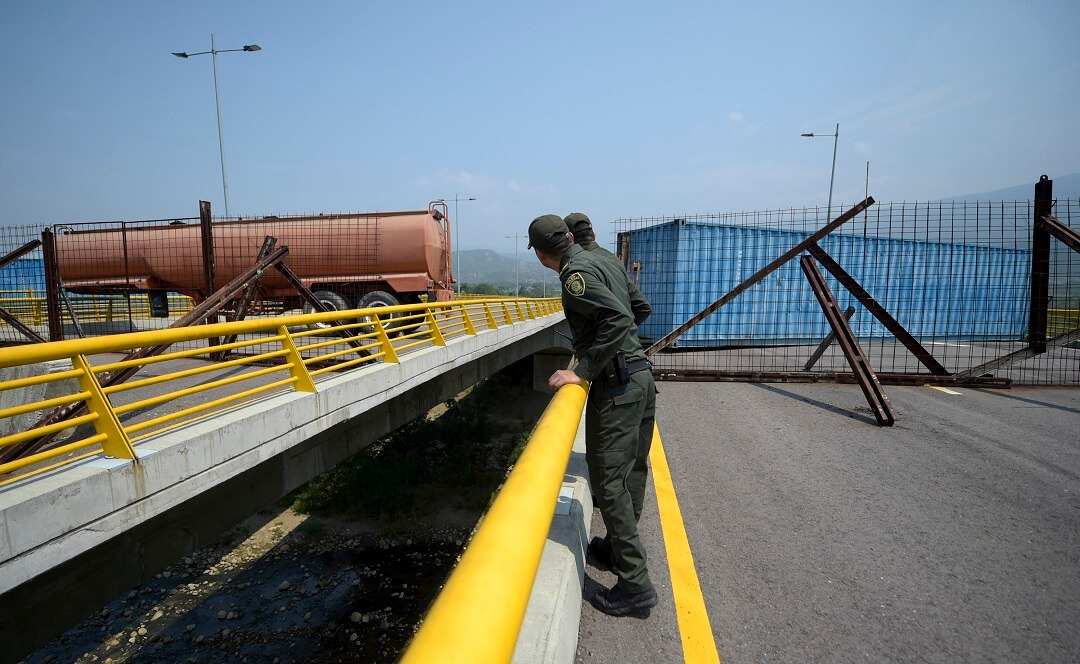 Containers block a key border bridge between Venezuela and Colombia.