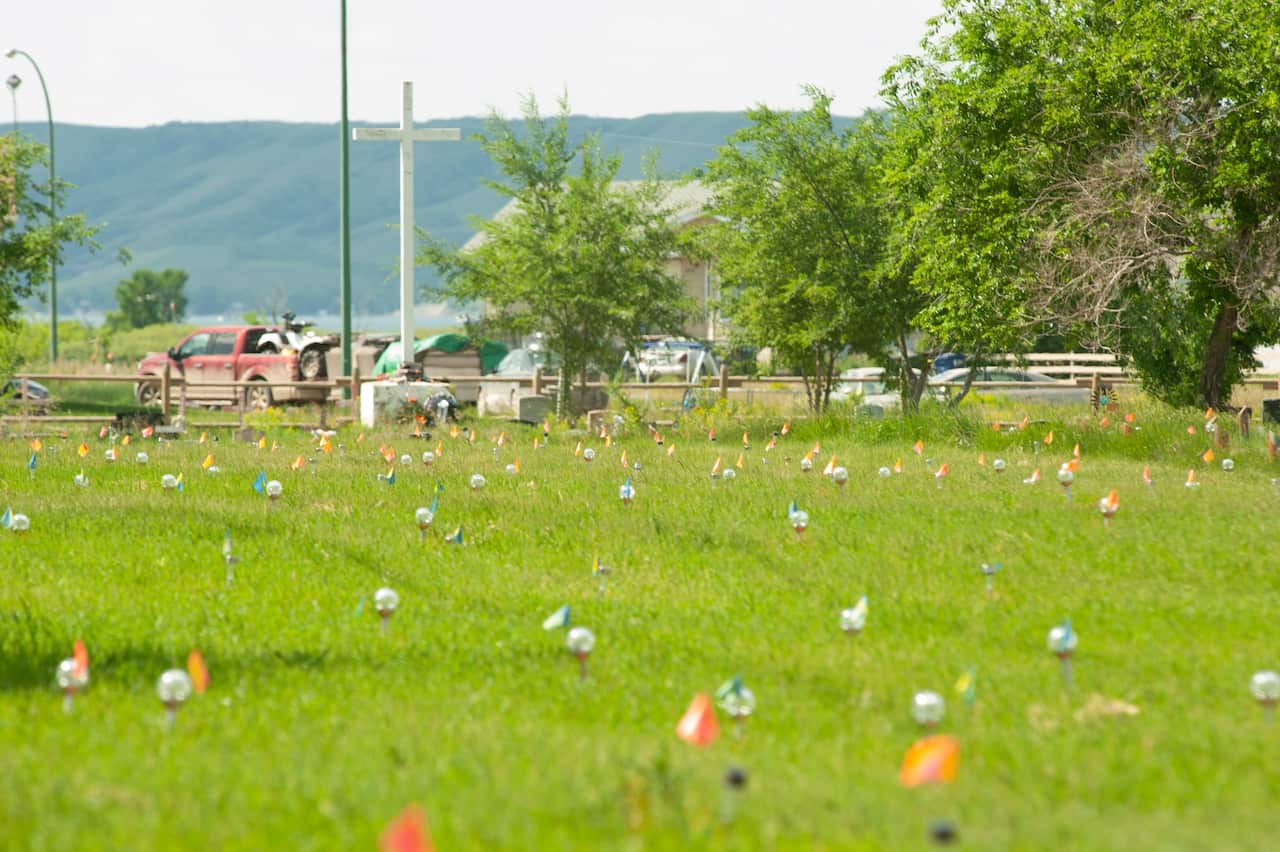 Flags and lights mark the 751 unmarked graves found near the grounds of the former Marieval Indian Residential School in Saskatchewan, Canada.