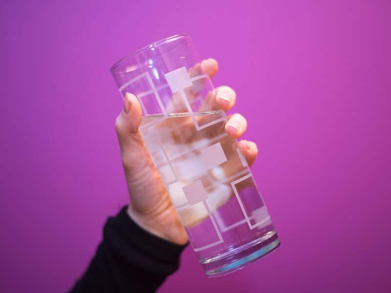 Someone holding a glass of water