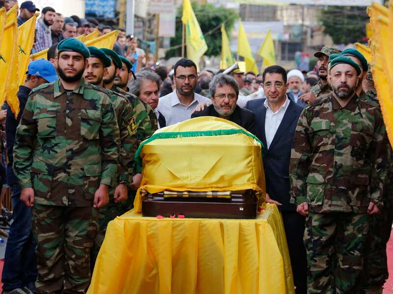 Hezbollah members carry the coffin of  commander Mustafa Badreddine