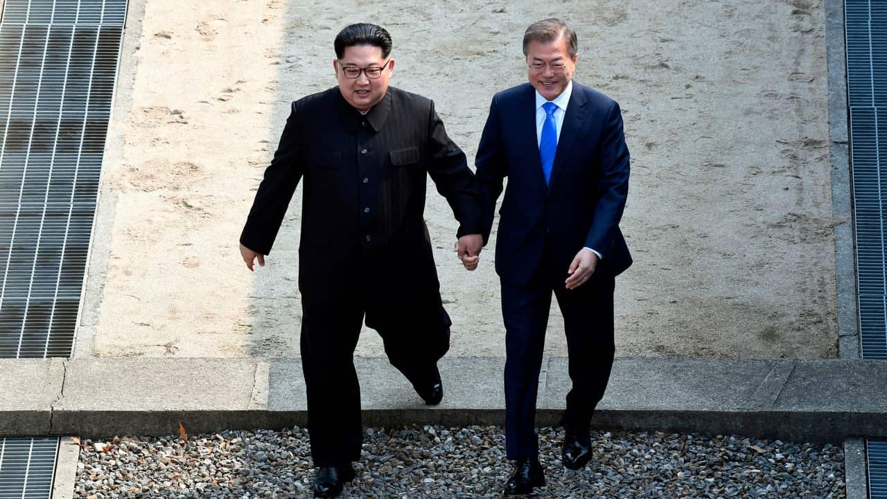 North Korean leader Kim Jong Un and South Korean President Moon Jae-in cross the military demarcation line at the border village of Panmunjom on 27 April, 2018.