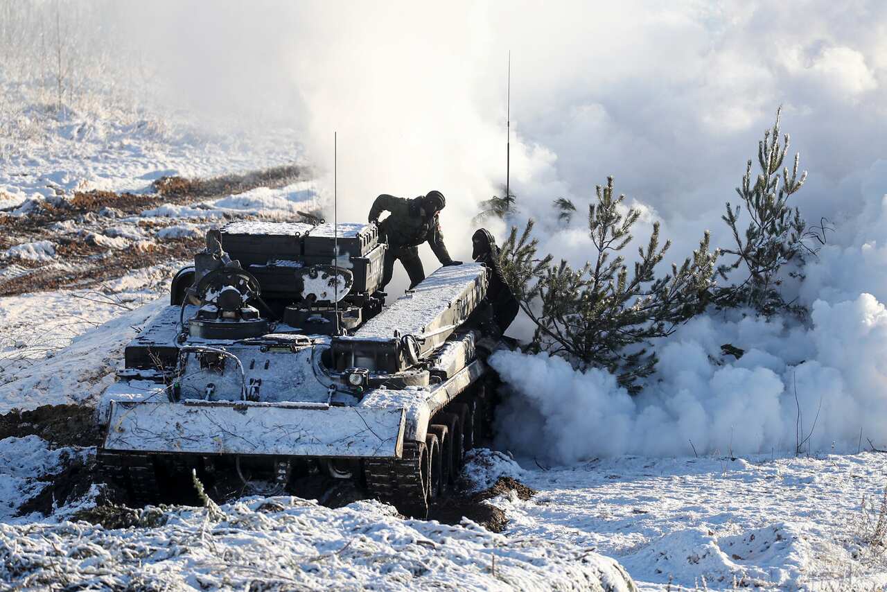Soldiers work with their military vehicle at the during the Union Courage-2022 Russia-Belarus military drills in Belarus, a country that neighbours Ukraine.