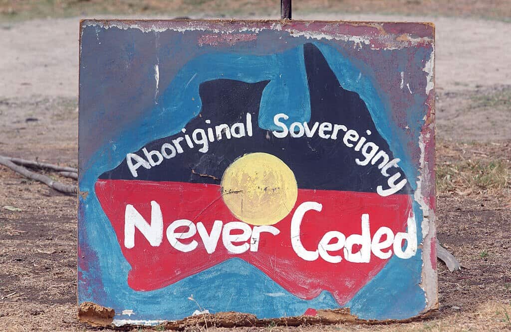 Aboriginal placard reads Aboriginal Sovereignty Never Ceded
