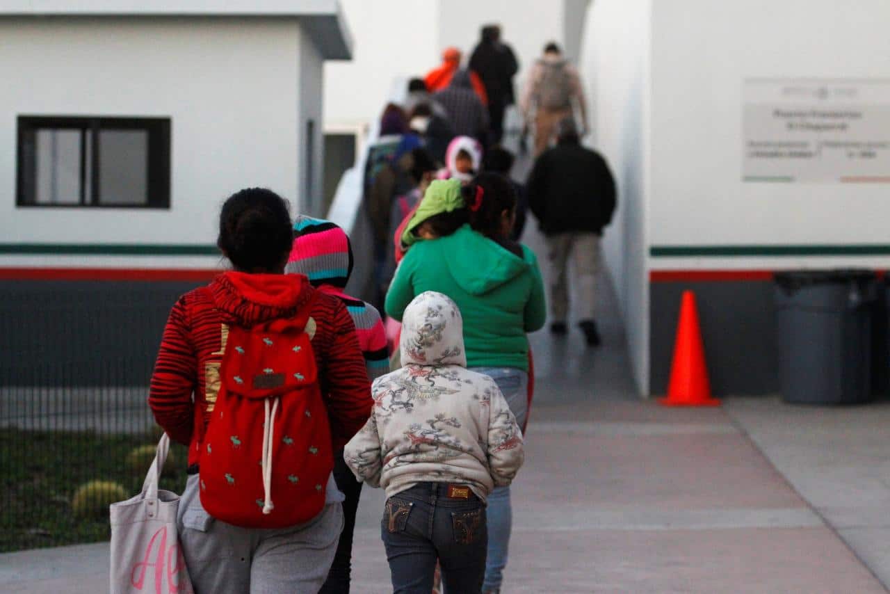 Immigrants from Central America and Mexican citizens prepare to cross into the U.S. to apply for asylum in Tijuana, Mexico.