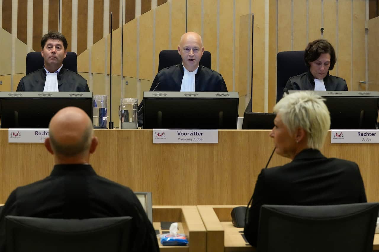 Presiding judge Hendrik Steenhuis waits for Ria van der Steen, who lost her father and stepmother in the MH17 crash.