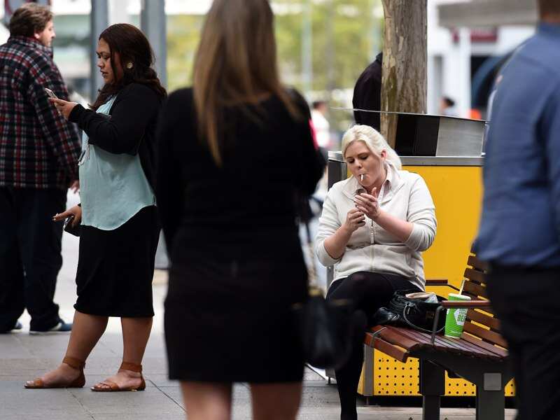 People smoke during lunchtime in central Brisbane