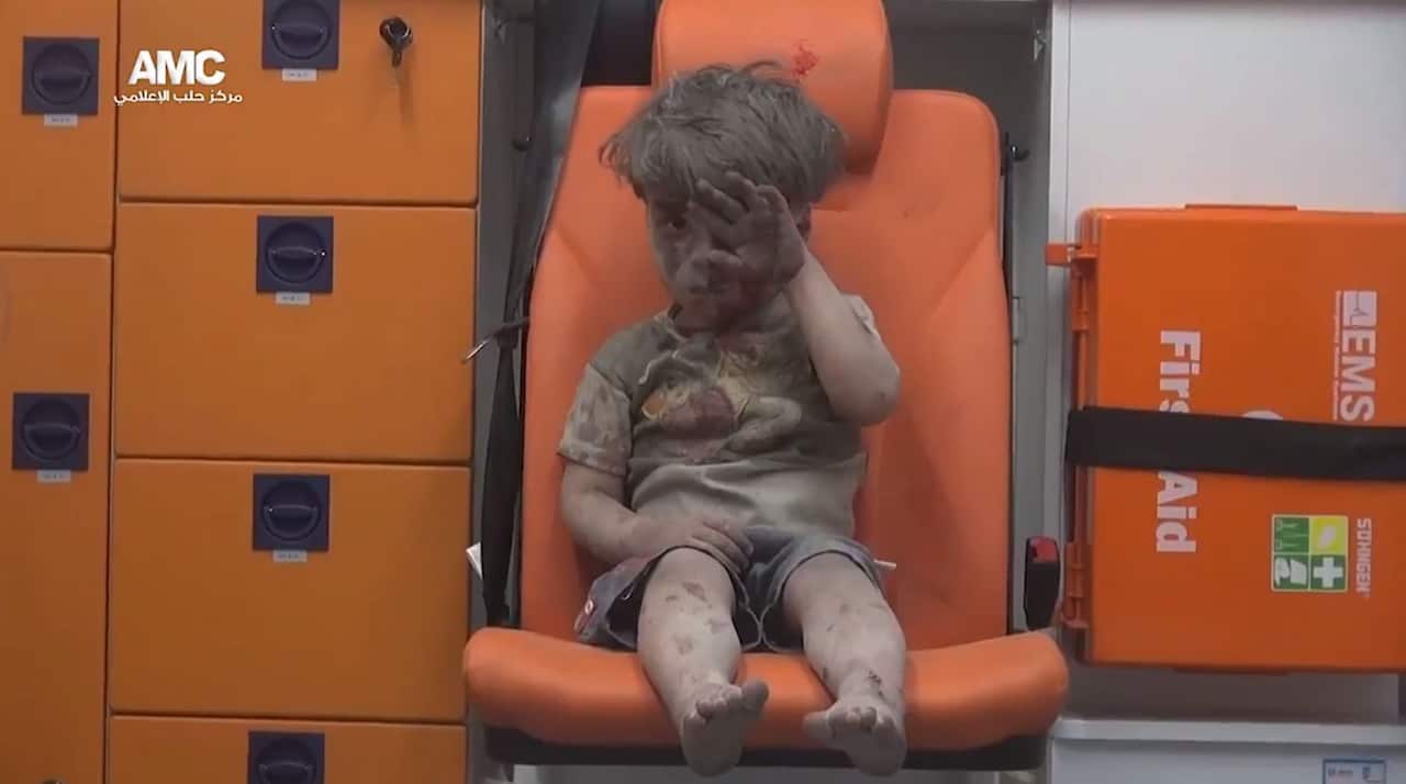 Omar Daqneesh, a five-year old Syrian boy, sitting in an ambulance after an alleged airstrike hit a house in Aleppo, Syria, 17 August 2016.