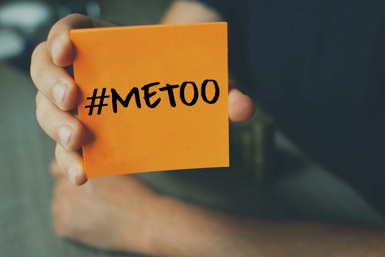 Me Too hashtag on orange note paper , anti sexual harassment social media campaign