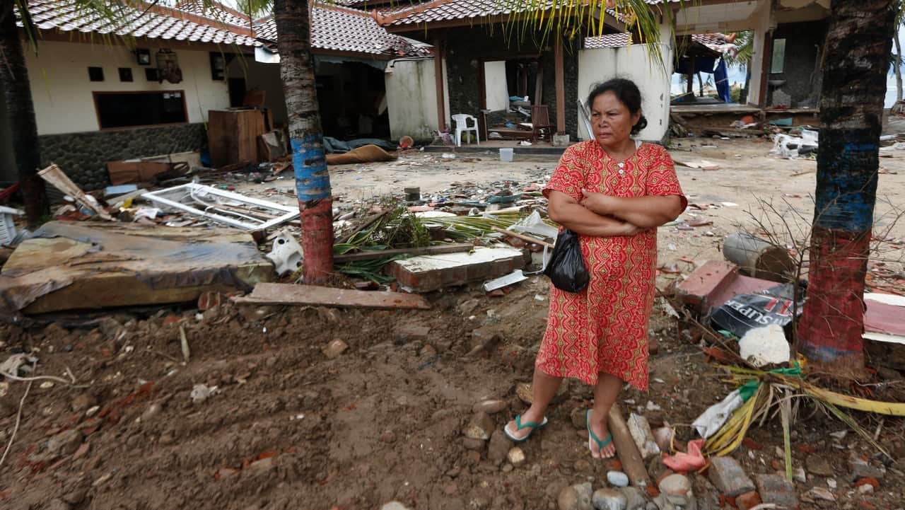 A Tsunami survivor, Sumiati, stands among debris in a devastated area after a tsunami hit Sunda Strait in Carita, Banten, Indonesia, 26 December 2018.  