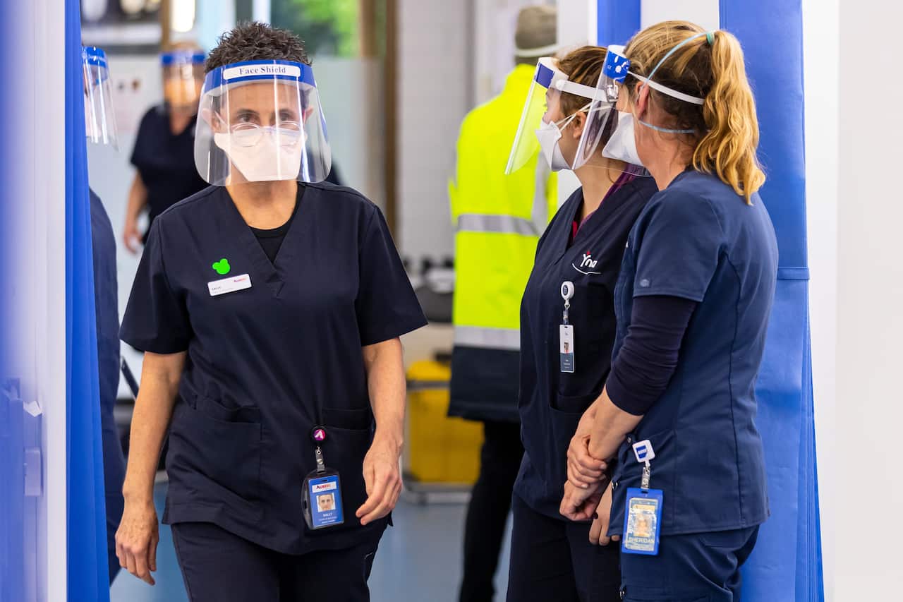 Healthcare workers are seen in the COVID vaccination hub at the Heidelberg Repatriation Hospital in Melbourne, 13 September.