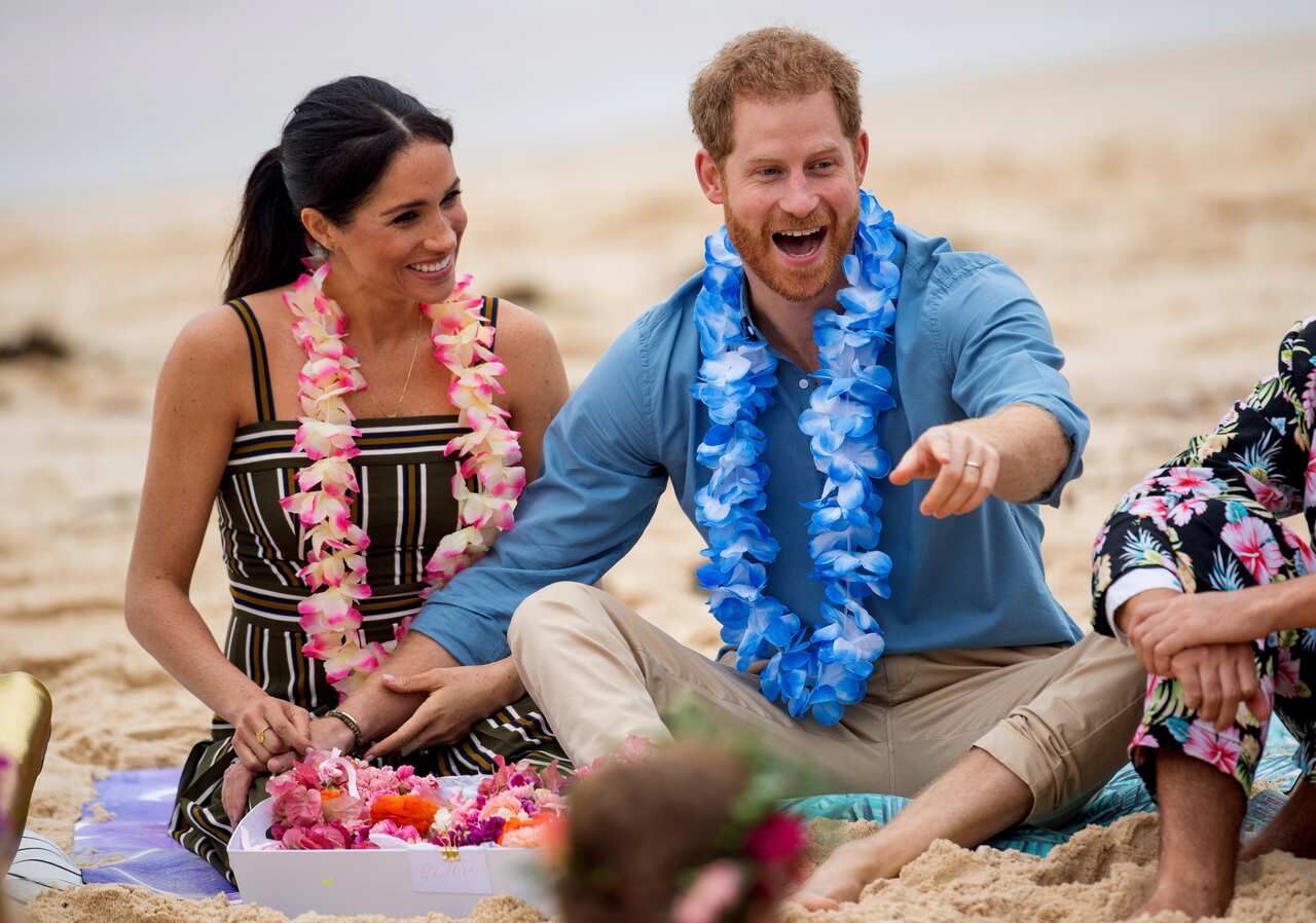 Britain's Prince Harry and Meghan, Duchess of Sussex meet with a local surfing community group at Sydney's Bondi Beach.