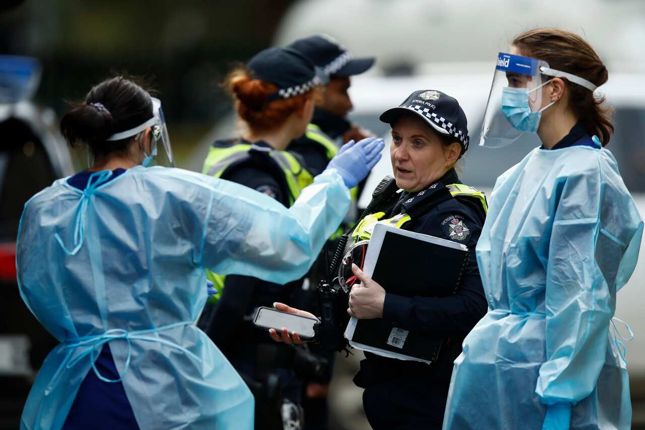 COVID-19 testing staff arrive at one of the public housing towers on Racecourse Road in Flemington, Melbourne, Sunday, 5 July, 2020. 
