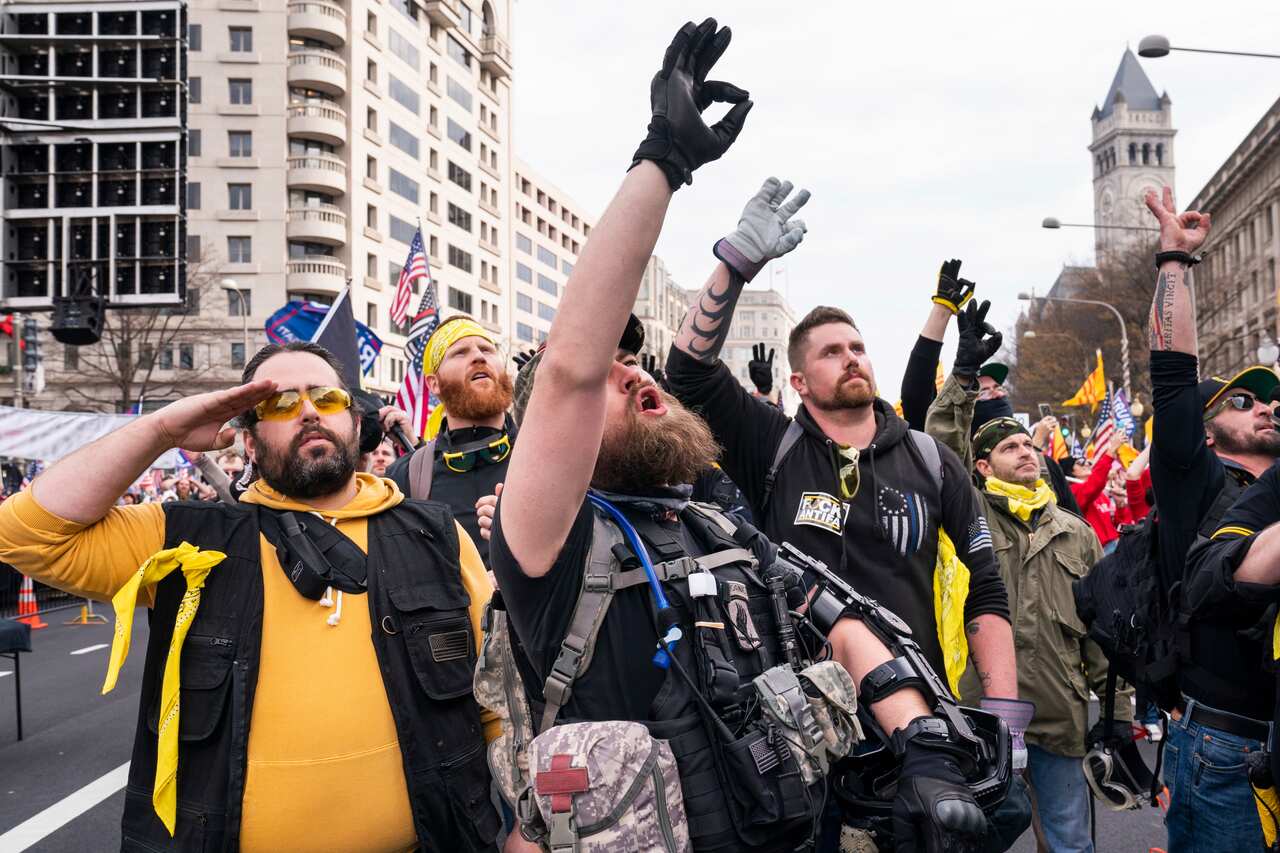 Members of the far-right group the Proud Boys gesture the 'white power' hand sign as they gather in Freedom Plaza, in Washington, DC, USA, 12 December 2020