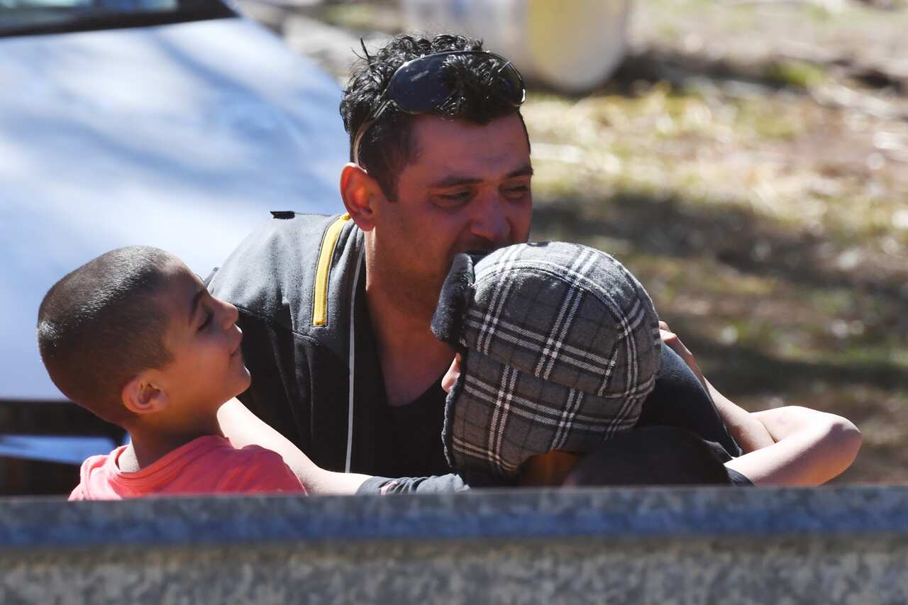Anthony Elfalak hugs two of his other sons after AJ was found alive