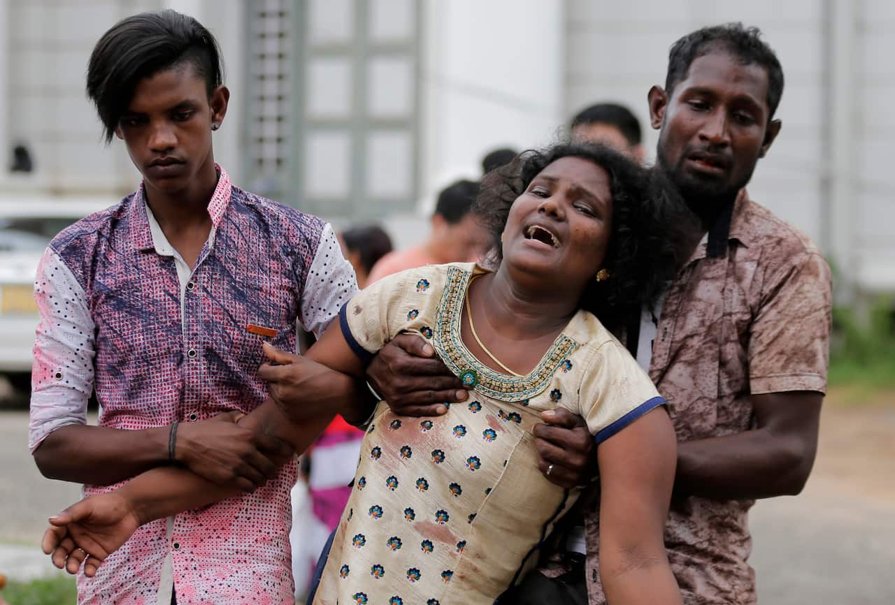 Relatives of a blast victim grieve outside a morgue in Colombo, Sri Lanka, Sunday, April 21, 2019.  