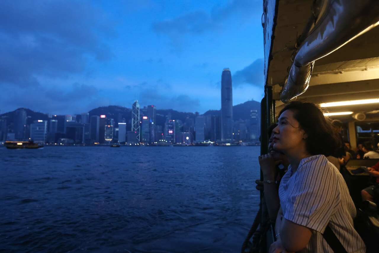 A woman looks out from the Star Ferry as the city's business district skyline is seen in the background in Hong Kong on June 3, 2018. (Photo by VIVEK PRAKASH / AFP) (Photo credit should read VIVEK PRAKASH/AFP/Getty Images)