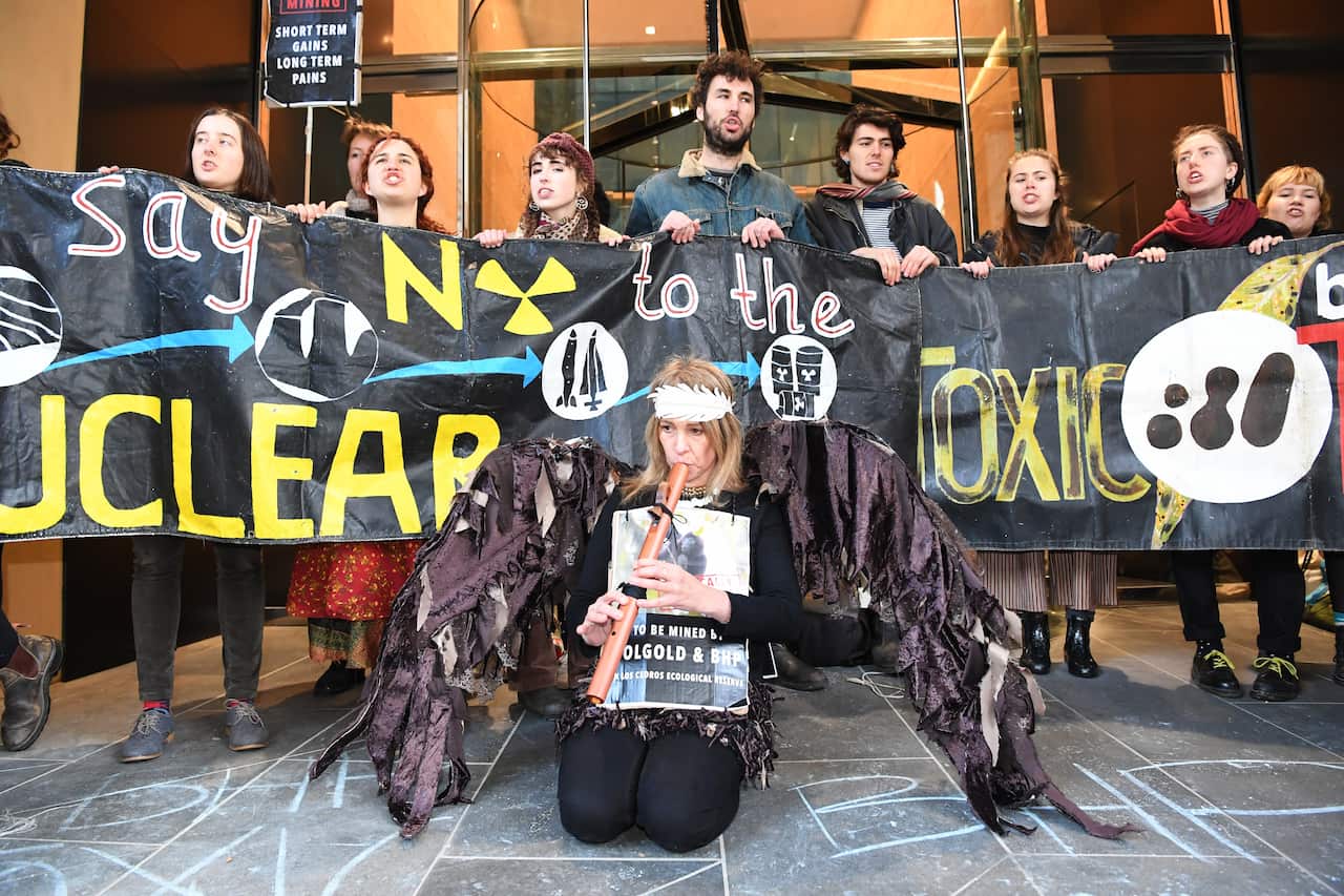 Protesters are seen outside of the BHP offices in Melbourne's CBD, Wednesday, July 11, 2018. 