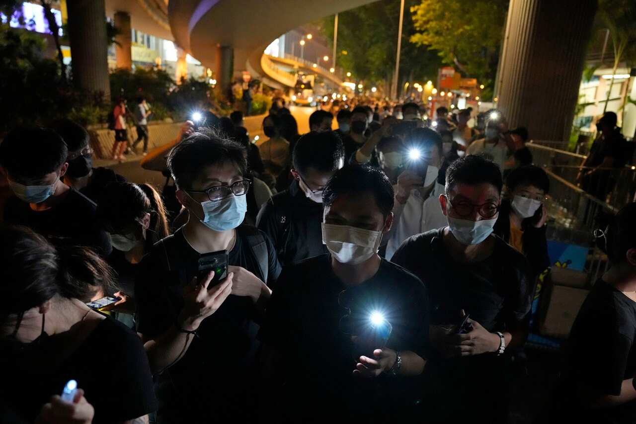 People light up led candle outside the Victoria Park in Hong Kong on 4 June 2021. 