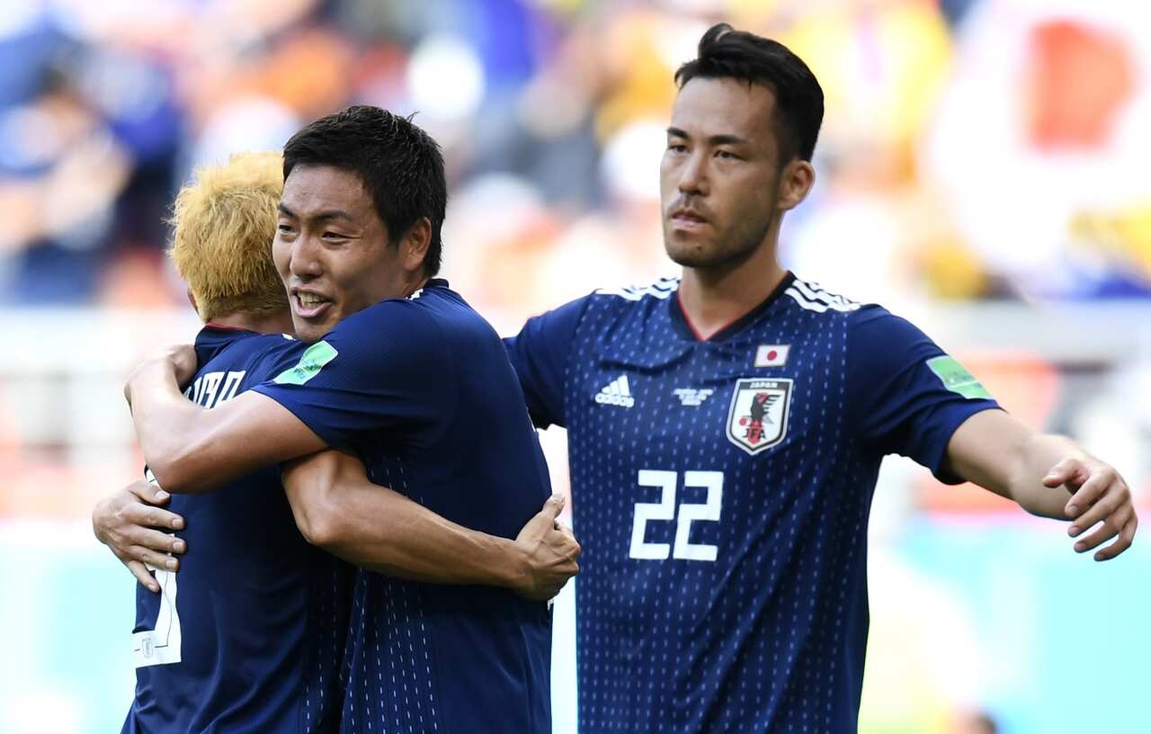 Gen Shoji, Yuto Nagatomo and Maya Yoshida of Japan celebrate victory