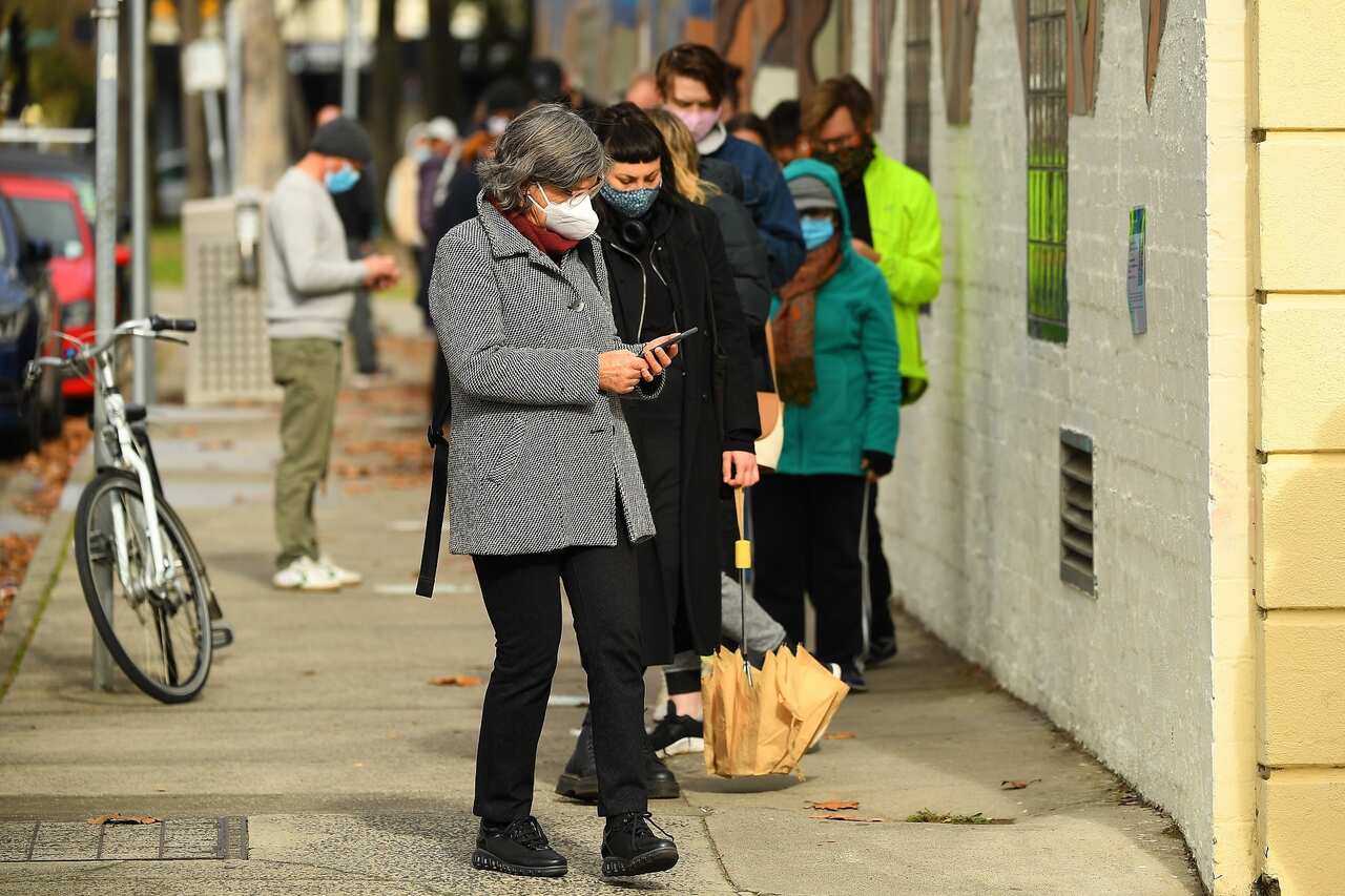 People are seen waiting in a line to receive covid19 tests at a walk-in covid19 testing facility in Melbourne