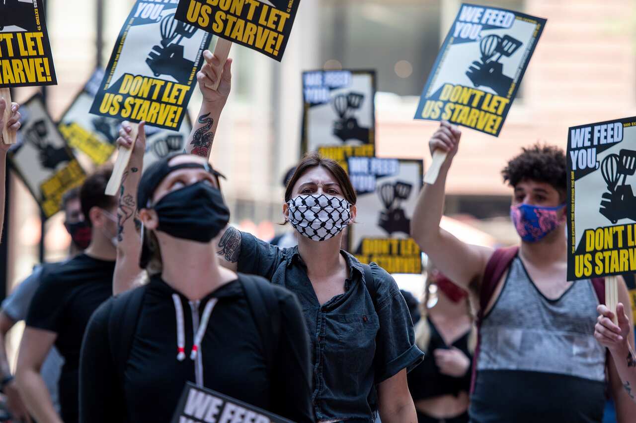 Restaurant workers rally in Chicago on July 24, calling for the Pandemic Unemployment Insurance program to be extended