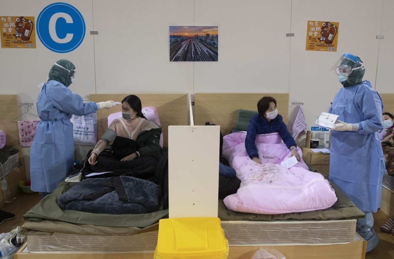 Medical staff attend to patients in Wuhan Fangcang hospital, a makeshift hospital to treat Covid-19 patients in Wuhan City, Hubei Province, China, 14 February 
