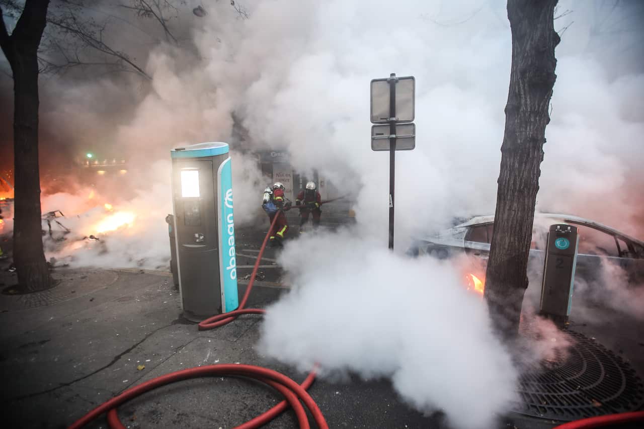 Several cars burn during a protest against France's controversial global security law on 5 December, 2020. 