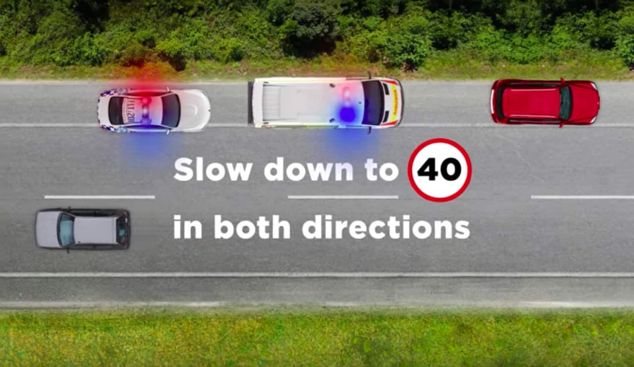 Drivers must slow down to 40 kilometres per hour if an emergency services vehicle is stopped on the road with blue or red lights flashing. Source: YouTube/Transport For NSW