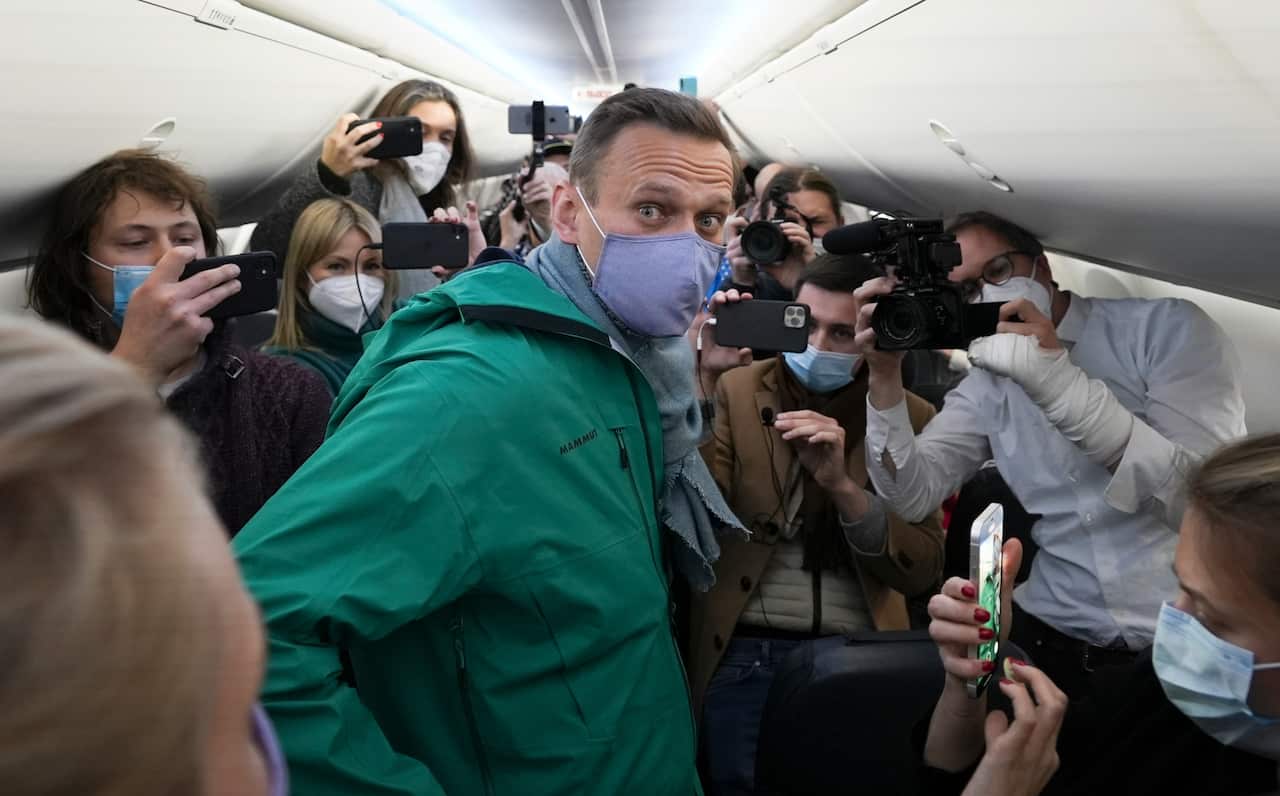 Alexei Navalny is surrounded by journalists prior to his flight to Moscow in the Airport Berlin Brandenburg (BER) in Schoenefeld, Germany, on 17 January.