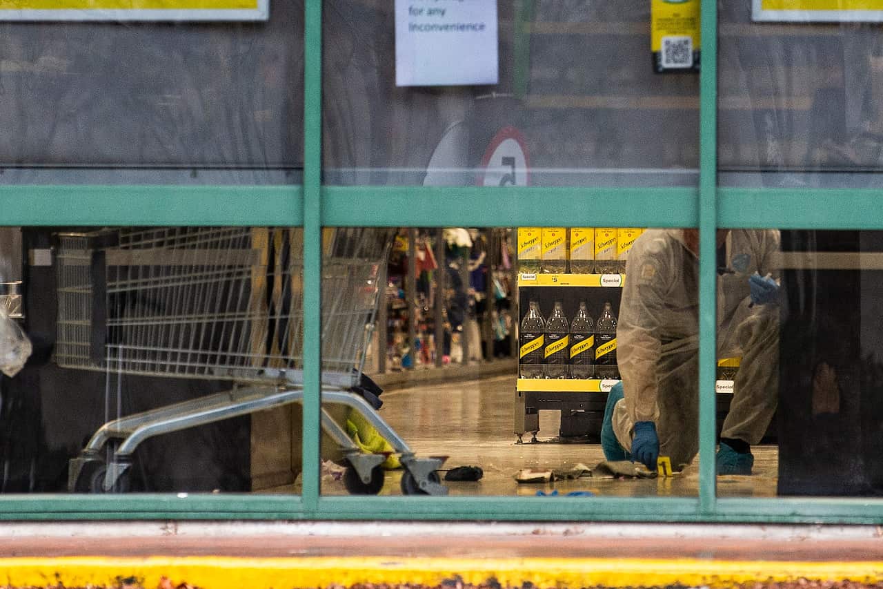 Police forensics staff are observed inside the Dunedin Central Countdown on 11 May, 2021 in New Zealand.
