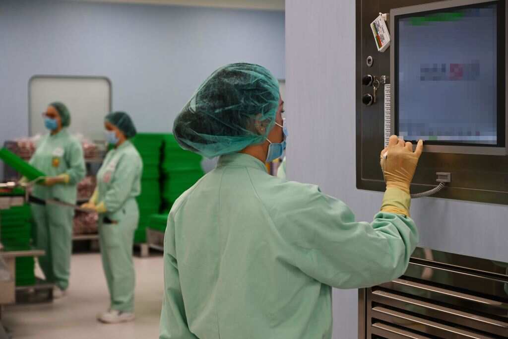 A laboratory technician supervises filling and packaging tests for the large-scale production and supply of the University of Oxfords COVID-19 vaccine candidate