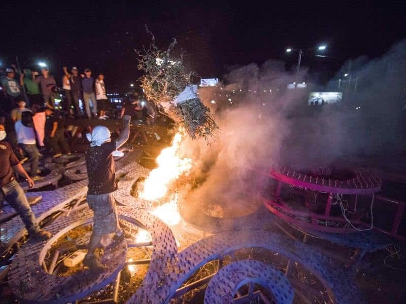 Protesters set fire to a government poster