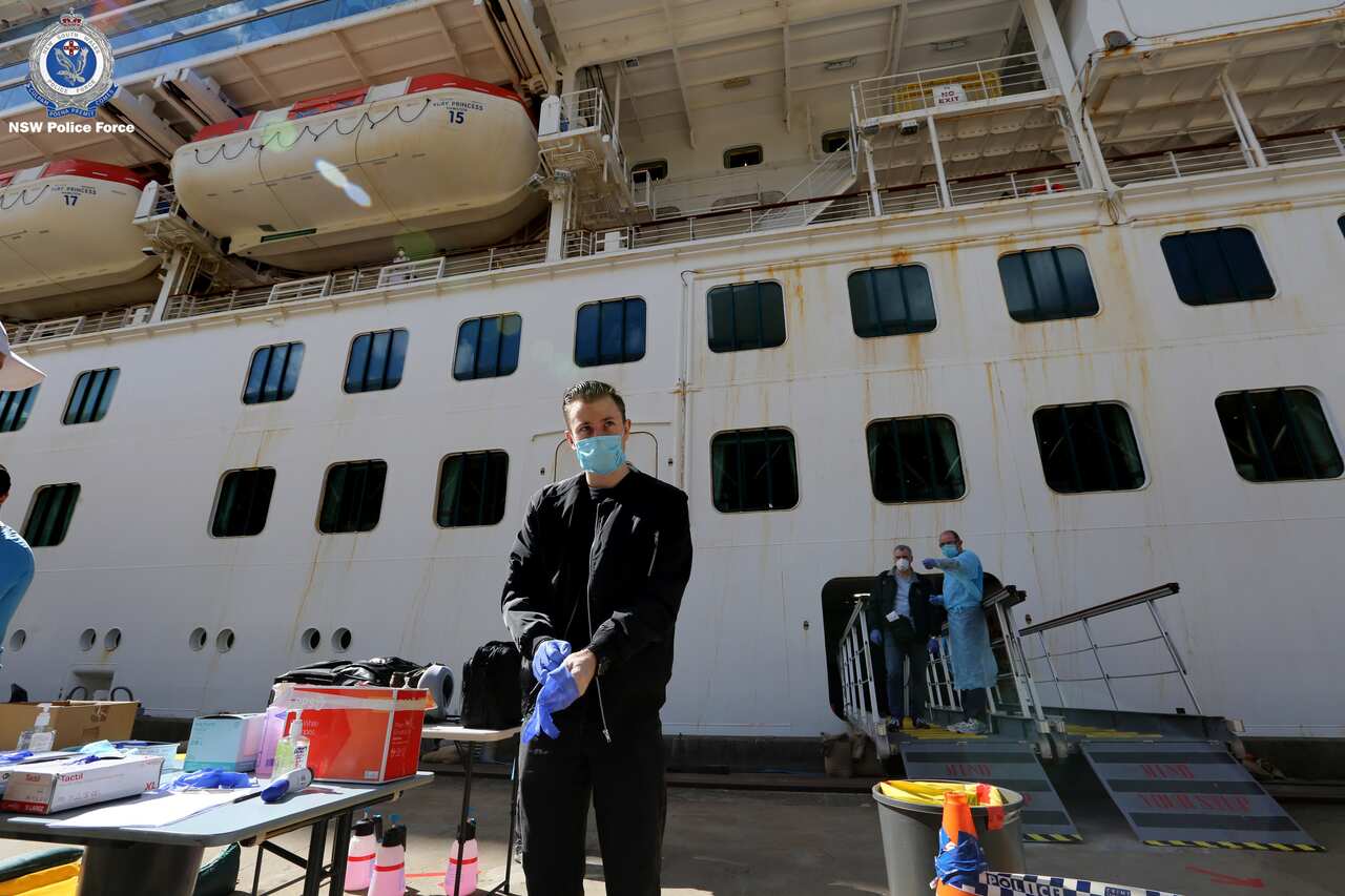 Crew members of the Ruby Princess cruise ship leaving the vessel which has been docked at Port Kembla for more than two weeks.