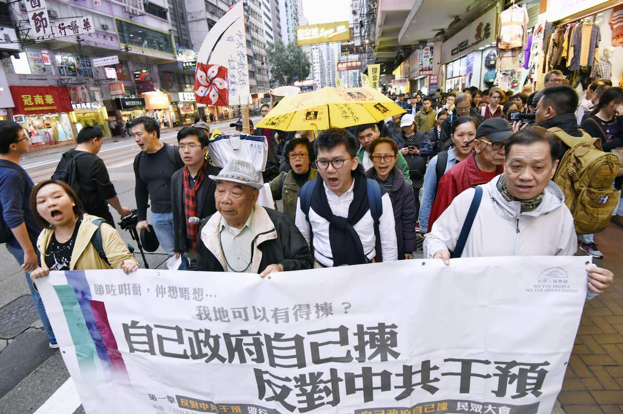 Pro-democracy campaigners take to the streets on March 25, 2017, on the eve of Hong Kong's leadership contest, protesting against what they call the "small circle election" in which elites favored by Beijing will determine the outcome. (Kyodo)==Kyodo