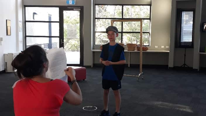 At the play rehearsals. 