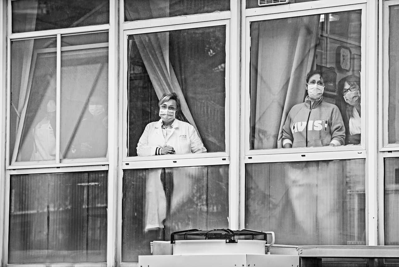 Doctors and nurses at a hospital window