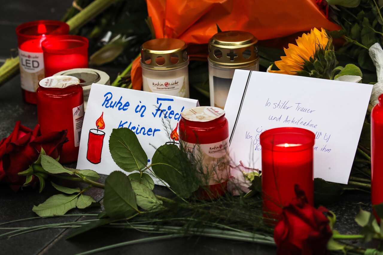 People put flowers and candles near the place where a child was pushed onto the tracks in Frankfurt's central station (Hauptbahnhof), Germany.