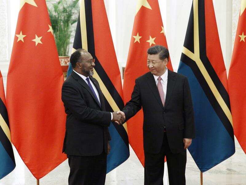 Vanuatu's Charlot Salwai (L) and China's Xi Jinping (R)