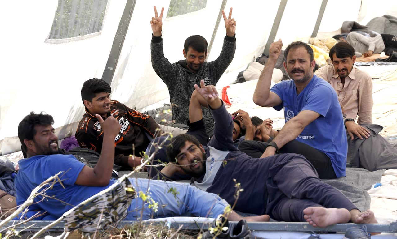 Migrants and refugees sit at a tent camp in Bihac, Bosnia and Herzegovina, 16 June 2019. 
