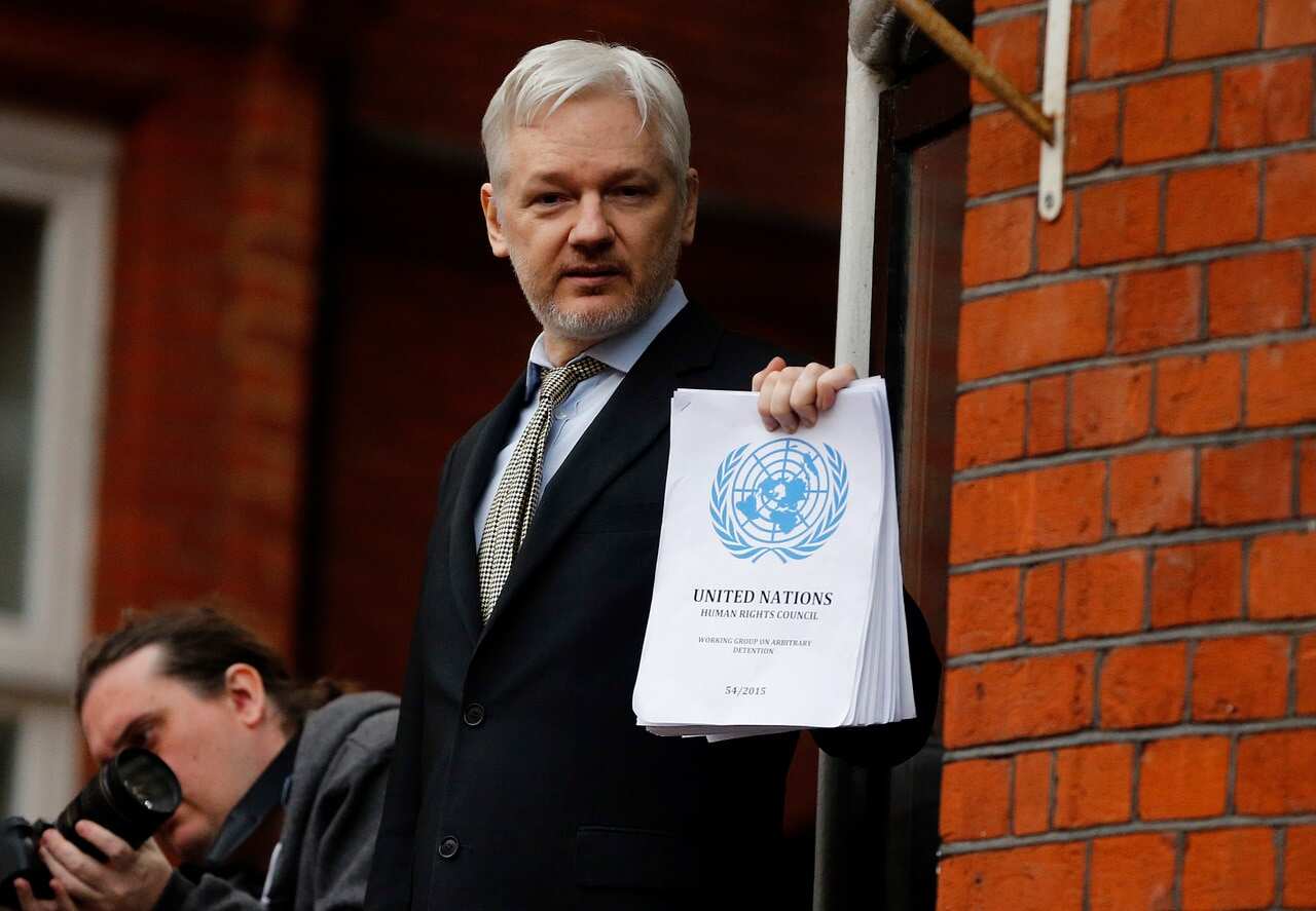 WikiLeaks founder Julian Assange stands on the balcony of the Ecuadorean Embassy to address waiting supporters on 5 February, 2016.  
