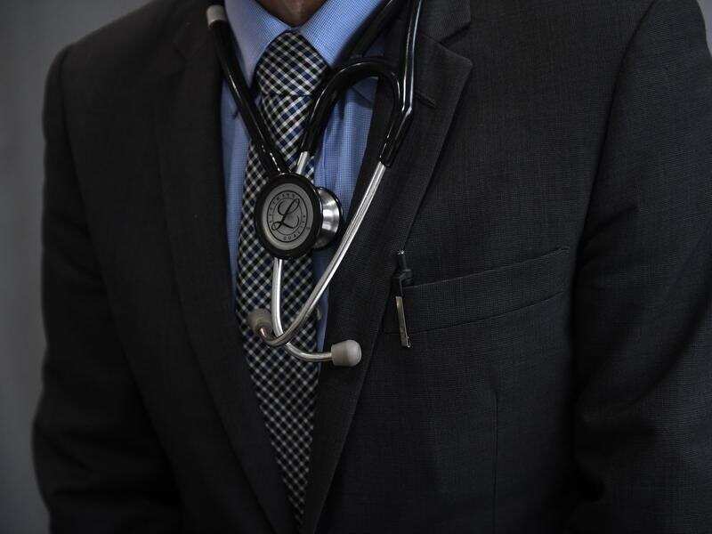 A medical doctor wears a stethoscope.