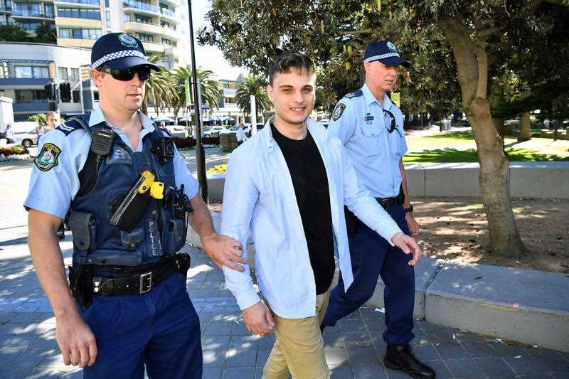 NSW Police detain a man after a confrontation with a photographer following a press conference with Senator Fraser Anning