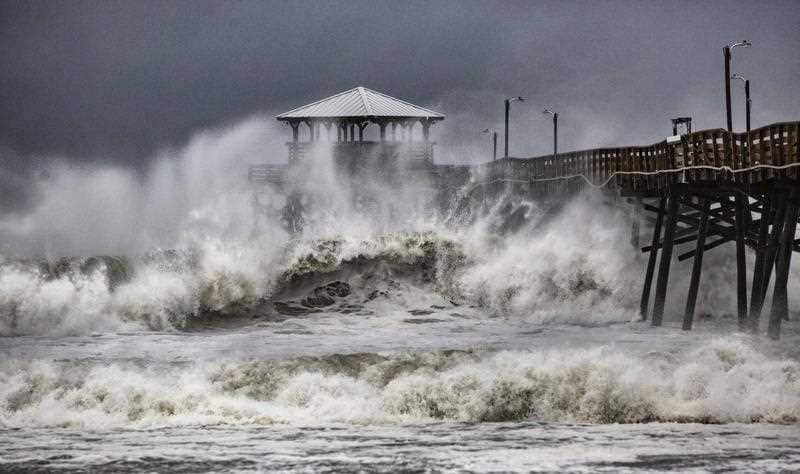 Waves slam the Oceana Pier & Pier House Restaurant in Atlantic Beach, N.C., Thursday, Sept. 13, 2018.