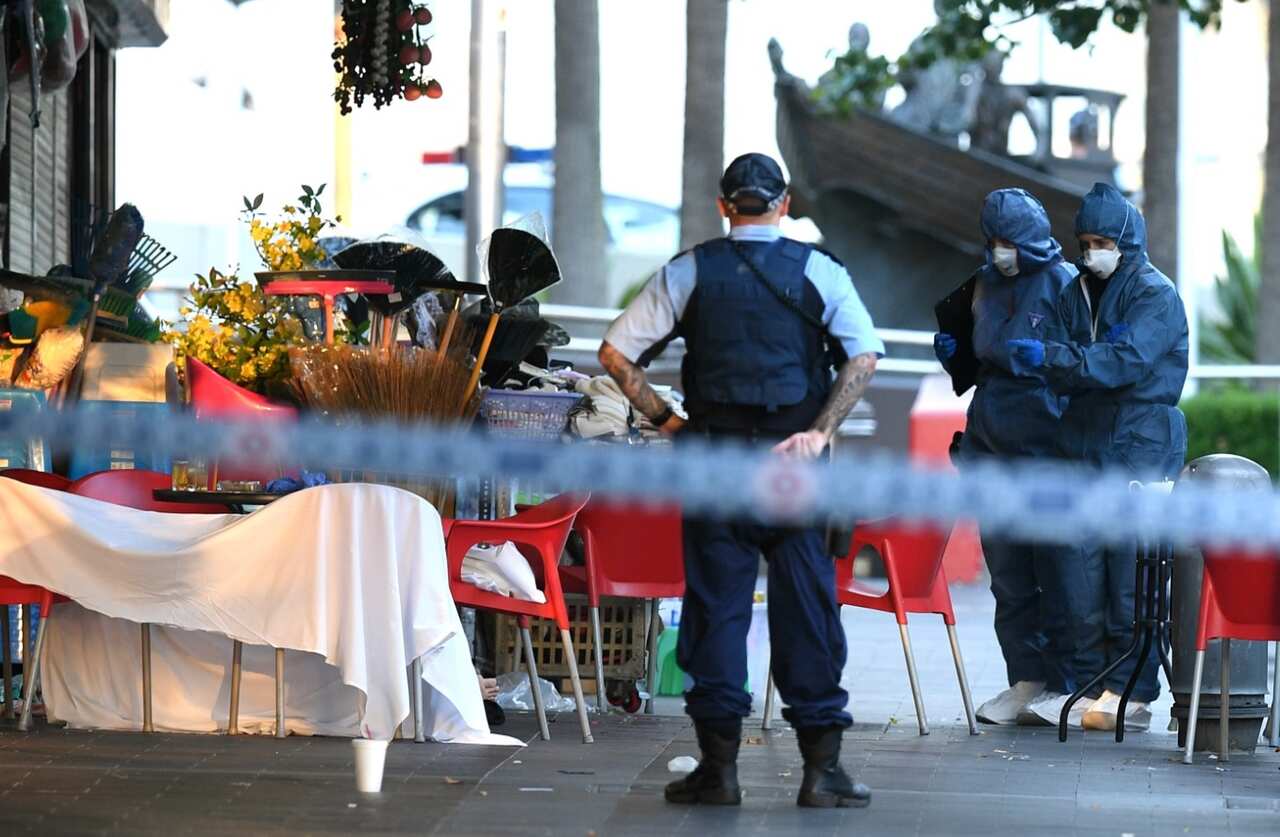 NSW Police and Forensic Services officers attend the scene of a shooting at a cafe at Bankstown City Plaza, in Bankstown, Tuesday, January 23, 2018 (AAP)