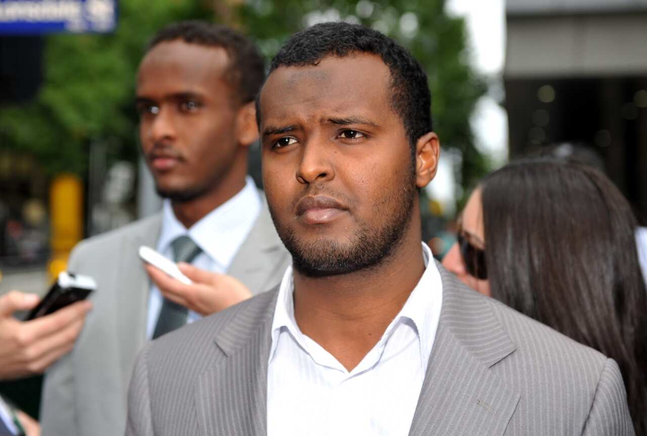 File image of Yacqub Khayre (centre) leaving court in Melbourne, Thursday, Dec. 23, 2010.