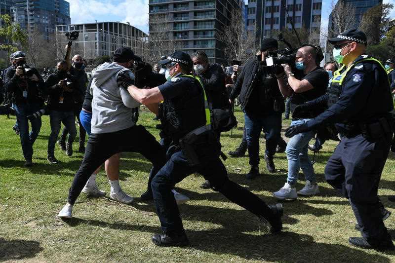 Police scuffle with protesters during an anti-lockdown protest in Melbourne, Saturday, September 5, 2020. 