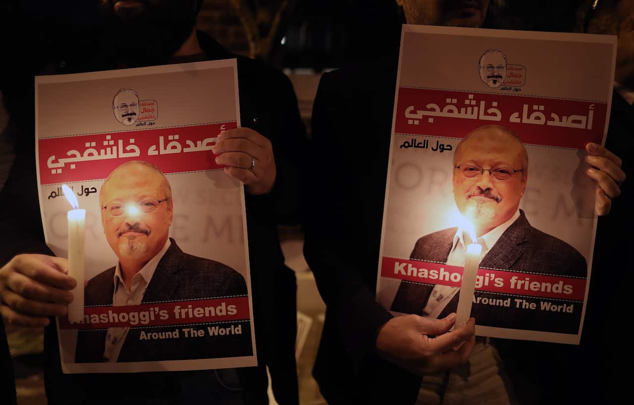 Protestors hold candles and pictures of Jamal Khashoggi during a demonstration in front of the Consulate of Saudi Arabia in Istanbul, Turkey.