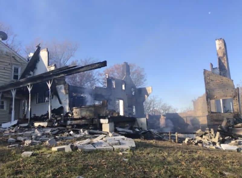 A house that was set on fire to make a smoke to keep out snakes and then burned down in a fire.
