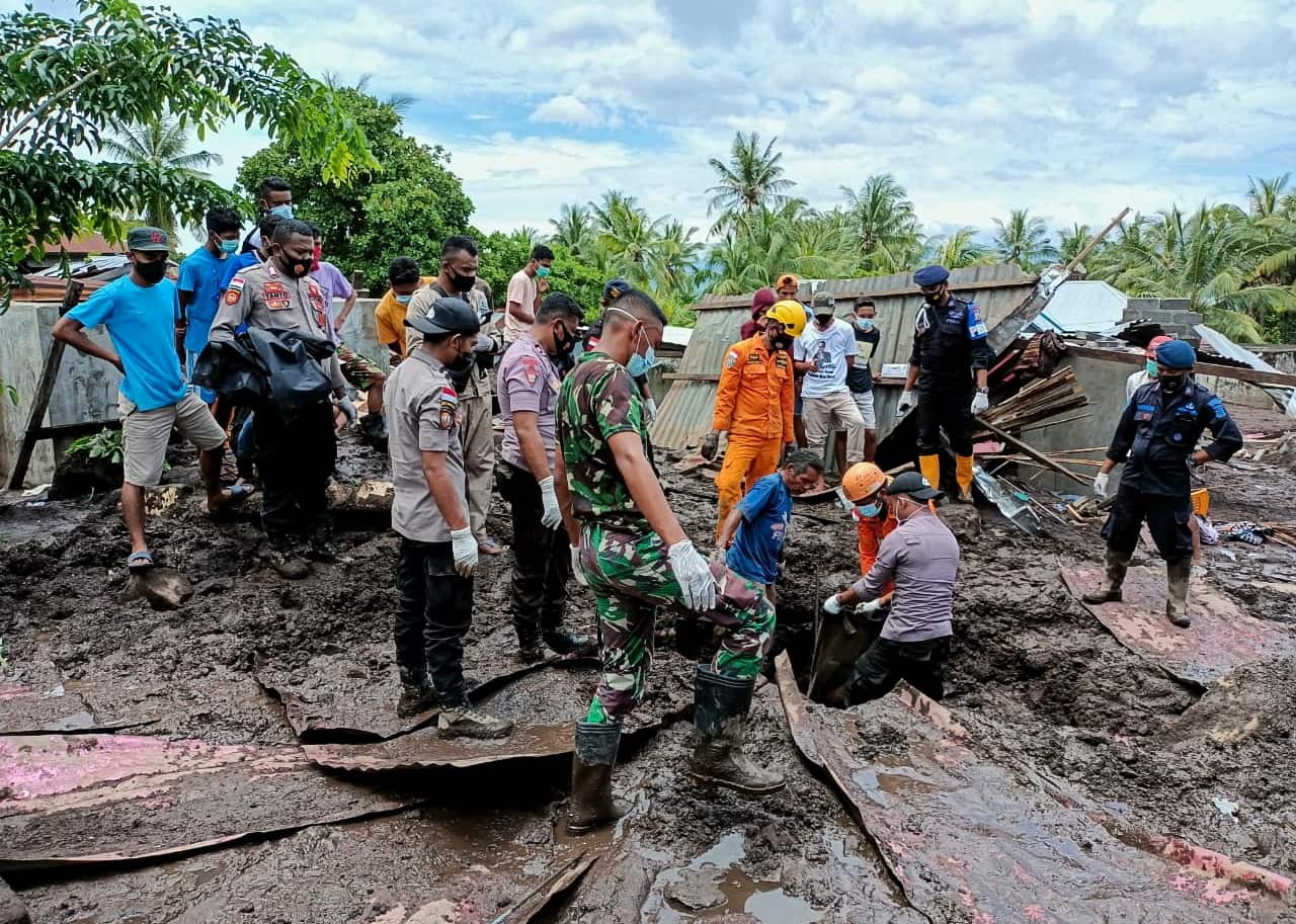 Rescuers search for victims under the debris on 6 April after a flash flood hit a village in Adonara, East Flores, Indonesia.