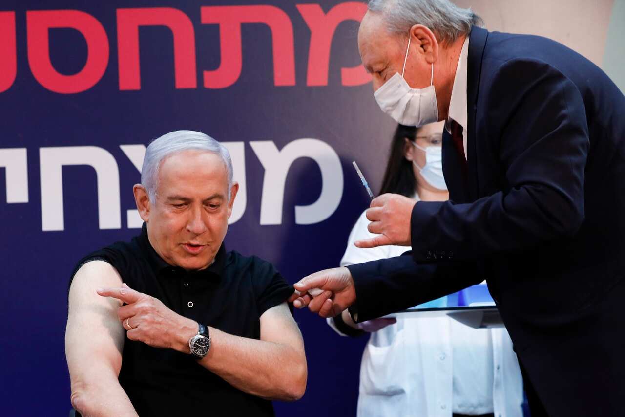 Israeli Prime Minister Minister Benjamin Netanyahu gets ready to receive a coronavirus vaccine at Sheba Medical Center on 19 December 2020. 